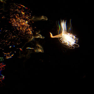 Underwater photo of fireworks looking like a hand of light
