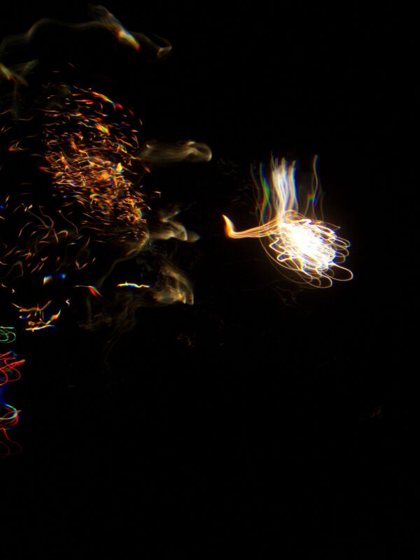 Underwater photo of fireworks looking like a hand of light